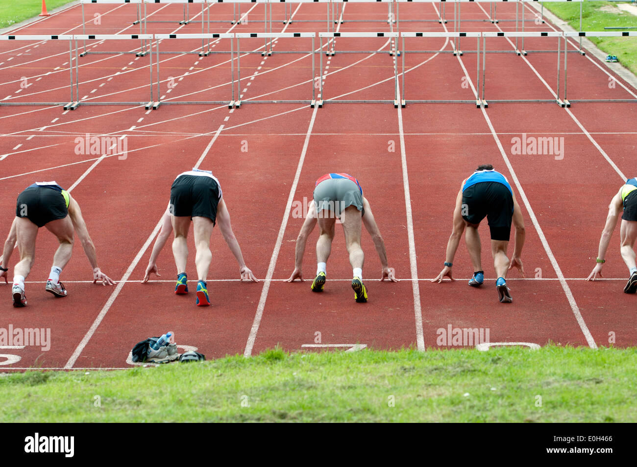 Athletics, runners at start of men`s 110m hurdles race at club level